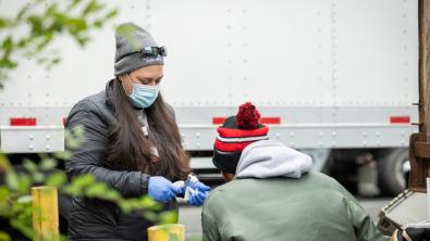 A nurse examining a patient in the field